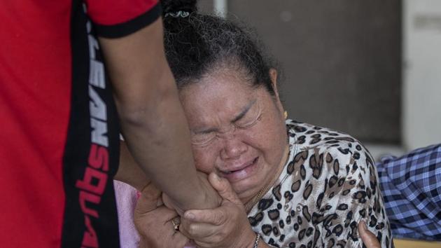 People comfort the relative of a victim in the mass shooting in Korat, Nakhon Ratchasima, Thailand, Sunday, Feb. 9, 2020.(AP)