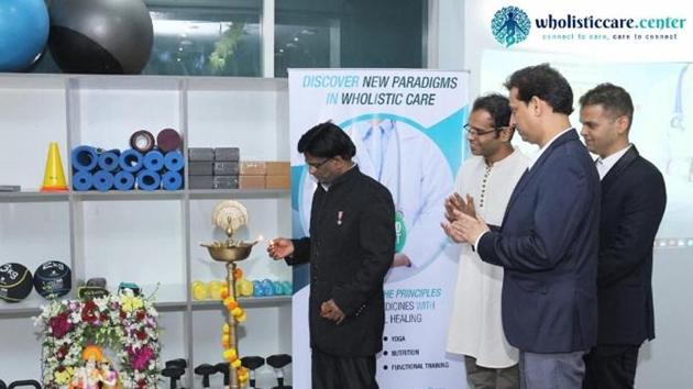 Dr. John Ebnezar lighting the auspicious lamp and inaugurating the Wholistic Care Center in Mumbai as Yogi Sakha, Dr. Pradeep Singh (centre) and Dr. Saurabh Talekar (extreme right) watches.(Digpu)