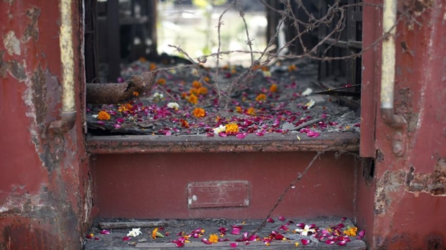 Flower petals scattered by the relatives of Godhra riots victims pictured at the doorsteps of a train carriage, that was set on fire in 2002, during the commemoration of the 12th anniversary of Godhra riots at Godhra. (File photo: Reuters) Flower petals scattered by the relatives of Godhra riots victims pictured at the doorsteps of a train carriage, that was set on fire in 2002, during the commemoration of the 12th anniversary of Godhra riots at Godhra. (File photo: Reuters)
