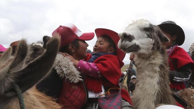 A mother embraces her child after he raced his llama at the Llanganates National Park. A llama named Rayo McQueen carried 6-year-old Eric Javier Chicaiza to a win in his category. His mother, Fátima Guanotuña, said the animal was a gift to the family when the boy was born, and the two have always been close. (Dolores Ochoa / AP)