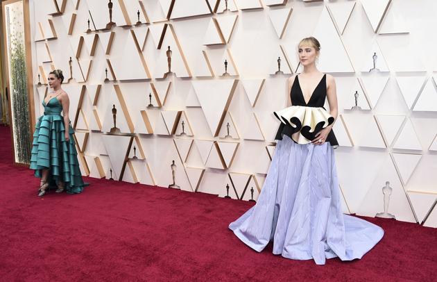 Florence Pugh, left, and Saoirse Ronan arrive at the Oscars on Sunday, Feb. 9, 2020, at the Dolby Theatre in Los Angeles. (Photo by Jordan Strauss/Invision/AP) (Jordan Strauss/Invision/AP)