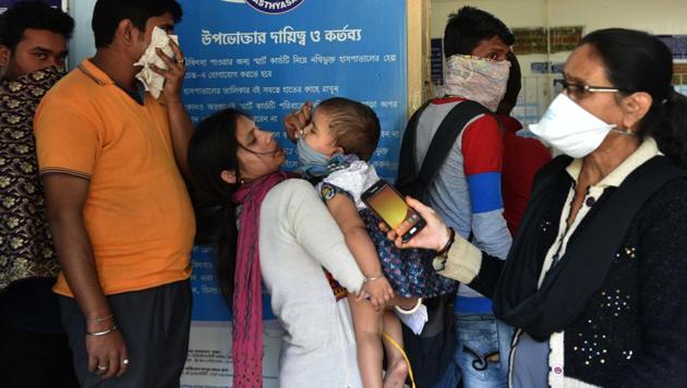 A woman covers the face of a child at the emergency ward of the Beleghata ID and BG. Hospital, where people have been wearing masks for safety from coronavirus in Kolkata, West Bengal, on February 3. The hospital super has claimed four people with suspected infection of coronavirus have been admitted and kept under observation. A German institute has ranked India 17th among the list of countries most likely to import cases of the novel coronavirus. (Samir Jana / HT Photo)