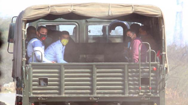 Army personnel sport masks as they move out of the camp in a truck, at Manesar, Gurugram. People who returned from China have been quarantined in the camp owing to fears of coronavirus infection. Meanwhile, 15 students from Kerala, who were stranded in Hubei in China’s Wuhan, reached Kochi on Friday night onboard an Air Asia flight. They were screened at the airport and taken to the Kalamassery Medical College hospital in sterilised ambulances. (Yogendra Kumar / HT Photo)