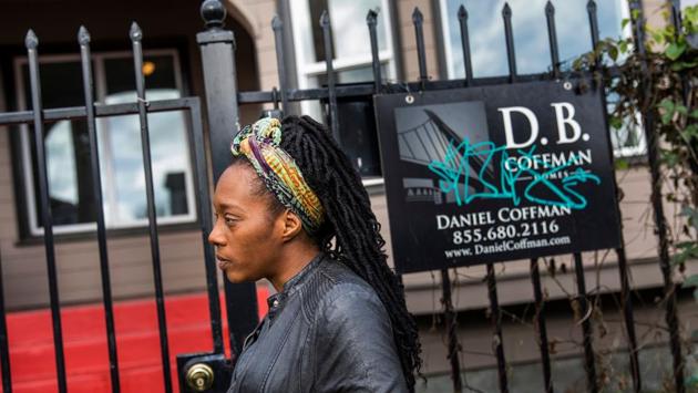 Dominique Walker stands in front of a vacant home. Kaplan said the main reason is residents losing their home because of foreclosure, rising rents, and real estate speculators driving up prices. Compounding the problem is a boom in San Francisco and the Silicon Valley where thousands of jobs are being created with little affordable housing being built in the region to absorb the increased workforce. (Philip Pacheco / AFP)