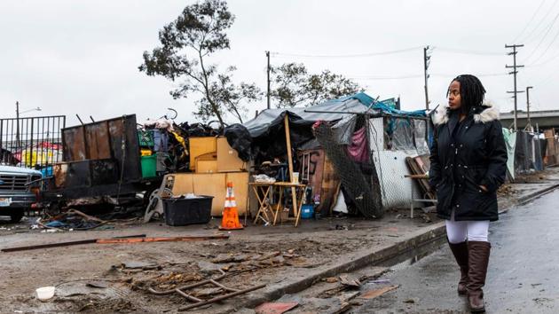 Carroll Fife walks outside a homeless encampment in Oakland. “We have reached a crisis point in the last two years,” Fife, a regional director with the Alliance of Californians for Community Empowerment, where Walker is employed, said to AFP. “It’s a combination of several issues that have just come together to create the perfect storm of unsustainable housing, lack of affordable housing.” (Philip Pacheco / AFP)