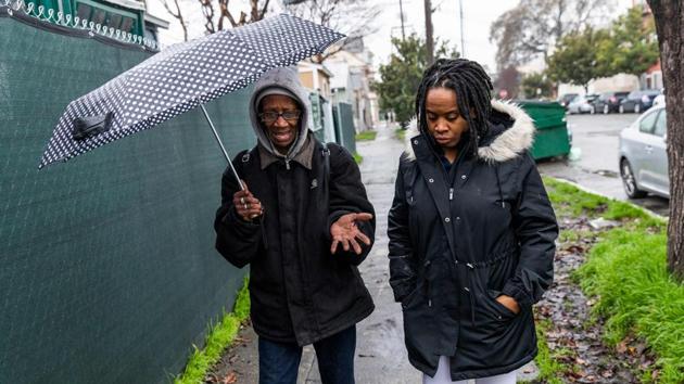 Carroll Fife (R),talks with an insecurely housed resident of Oakland. Fife said that unless emergency measures to tackle the crisis and address housing as a human right are taken, more actions like the one by Moms 4 Housing will take place. “Our city, our state, our federal government can do more to end this,” she said, as she took AFP on a tour of the homeless encampments throughout the city. “If they wanted to, they could end it today.” (Philip Pacheco / AFP)