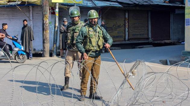 Security personnel stand guard at a blocked road, in Srinagar, Sunday, Feb. 9, 2020.(PTI photo)