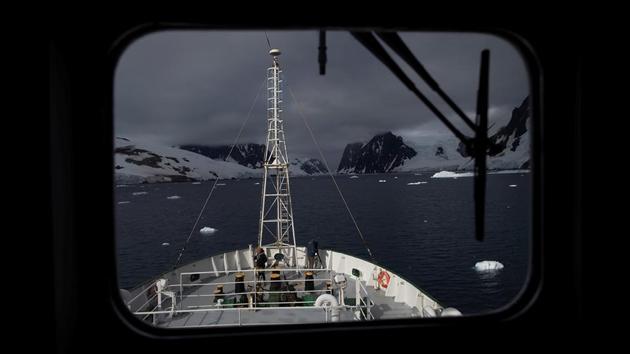 Crew members stand aboard the front of the Esperanza ship near Lemaire Channel. The scientists, travelling on two Greenpeace ships, the Esperanza and the Arctic Sunrise, conducted their expedition to Western Antarctica from January 5 to February 8, and used manual and drone surveying techniques to assess the scale of the damage. (Ueslei Marcelino / REUTERS)