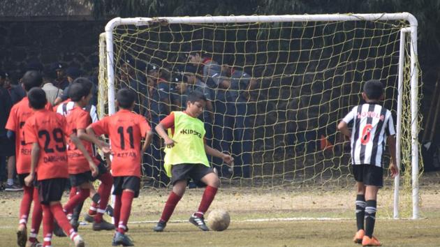 Players of Vidyankur School (red) and Loyola School (black and white) in action during the inaugural St Vincent’s junior league inter-school (U-12) football tournament played at St Vincent’s High School football ground on Saturday.(HT PHOTO)