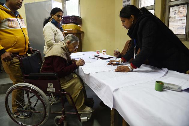 New Delhi, India - February 8, 2020: An elderly woman on a wheelchair casts her vote during Vidhan Sabha elections, at Sector 7, Dwarka, in New Delhi, India, on Saturday, February 8, 2020. (Photo by Vipin Kumar / Hindustan Times) (Vipin Kumar/HT PHOTO) New Delhi, India - February 8, 2020: An elderly woman on a wheelchair casts her vote during Vidhan Sabha elections, at Sector 7, Dwarka, in New Delhi, India, on Saturday, February 8, 2020. (Photo by Vipin Kumar / Hindustan Times) (Vipin Kumar/HT PHOTO)