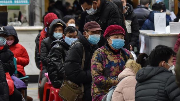 People in face masks wait at Wuhan Red Cross Hospital, on January 24. The city of 11 million was placed under an unprecedented quarantine to try and stop the spread of the novel coronavirus. The virus, which has since gone on to kill more than 1,000 people across China, is believed to have crossed into humans from an animal market in Wuhan. The AFP team arrived in Wuhan the day the city was place under lockdown. (Hector Retamal / AFP)
