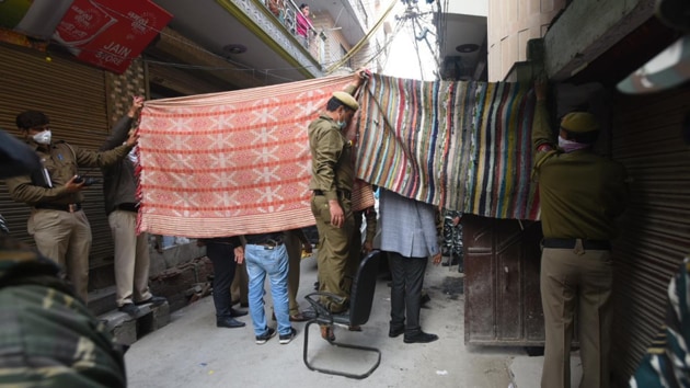 Delhi police officials covering the entrance of the house where the family of five lived in east Delhi’s Bhajanpura. (Photo: Amal KS/ Hindustan Times) Delhi police officials covering the entrance of the house where the family of five lived in east Delhi’s Bhajanpura. (Photo: Amal KS/ Hindustan Times)