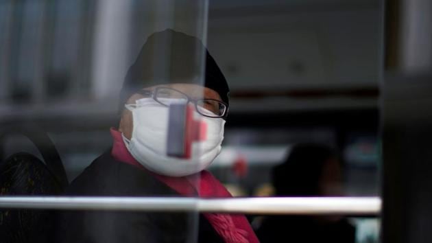 A man wearing a mask is seen on a bus, in downtown Shanghai, China, as the country is hit by an outbreak of a new coronavirus, February 12, 2020. (REUTERS) A man wearing a mask is seen on a bus, in downtown Shanghai, China, as the country is hit by an outbreak of a new coronavirus, February 12, 2020. (REUTERS)