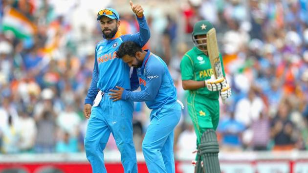 Kedar Jadhav of India celebrates the wicket of Babar Azam of Pakistan with Virat Kohli.(Getty Images)