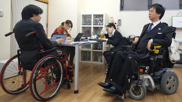 The new lawmakers have garnered plenty of support despite critics, particularly from within a community that often feels marginalised. “It’s important that we, those with disabilities, go out and raise our voices,” said Shinya Ando (R),paralysed from the chest down after a motorbike accident in his teens. Ando runs Personal Assistant Machida, a firm which dispatches some 250 helpers to disabled people. (Kazuhiro Nogi / AFP)
