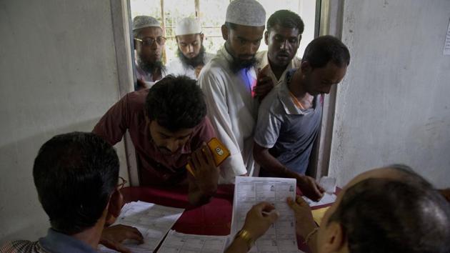 Villagers check for their names in the final list of the National Register of Citizens (NRC) at an NRC centre.(AP Photo)