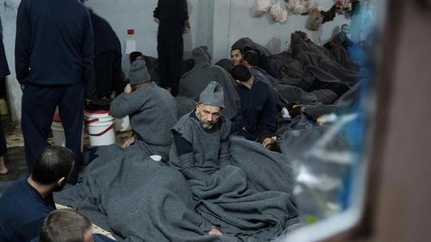 Prisoners suspected of being part of the Islamic State, in a prison cell in Hasaka. Reuters reporters saw more than 50 men lying head-to-toe across the floor of one cell, leaving virtually no room to move. Natural light was minimal and the air was heavy with the smell of sweat and dirt. (Goran Tomasevic / REUTERS)