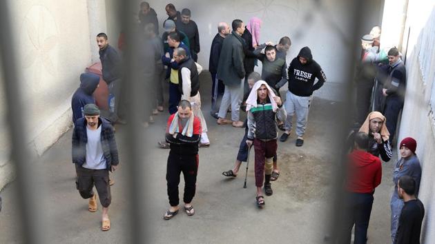 Prisoners from Iraq and Syria in a prison's outside grounds in Hasaka. “We want to know what our fate is,” said Mahmoud Mohammad, an IS fighter from Syria held in a prison near Hasaka, south of Qamishli.”We don’t know anything about our families,” he told Reuters in an interview arranged and supervised by Kurdish security forces during a sanctioned visit. (Goran Tomasevic / REUTERS)