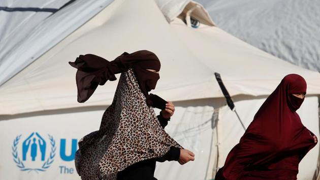 Women walk past a tent in al-Hol camp, Syria. “We don’t know if they’re alive or dead, in Syria or outside. I want to know my sentence and my fate.” Mohammad, whose nom de guerre is Abu Hamza, was one of nine men interviewed by Reuters in two prisons—one located near Hasaka and the other the town’s central jail. (Goran Tomasevic / REUTERS)