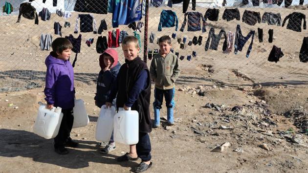 Beyond the prisons, thousands of mostly woman and children are detained in camps in the area. The al-Hol facility in Hasaka province is the biggest and holds tens of thousands of people in a sprawling camp of white canvas tents that provide minimal shelter from the winter cold and rain. Children play on muddy paths and large puddles full of refuse collect in open spaces. (Goran Tomasevic / REUTERS)