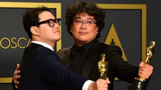"Parasite" writers Han Jin-won (L) and Bong Joon-ho pose in the press room with the Oscars for "Parasite" during the 92nd Oscars at the Dolby Theater in Hollywood, California on February 9, 2020. Bong Joon-ho won for Best Director, Best Movie, Best International Feature Film and Best Original Screenplay for "Parasite". (Frederic J. Brown / AFP)