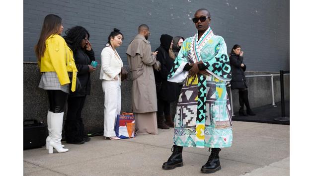 Sabrina-Anne Sarpong, founder of British media platform DSTNGR, poses for photographers outside a show. With the New York leg of the fashion calendar winding down this week,industry influencers, buyers and media will move on to the next round, London Fashion Week that begins Saturday. (Mark Lennihan / AP)