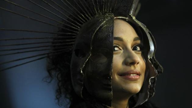 A model wears a creation made of chocolate backstage before a fashion show during an annual chocolate festival in Brussels, Thursday, Feb. 13, 2020. (AP Photo/Francisco Seco) (AP)