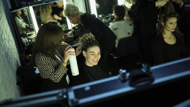 Models get their hair done backstage before a fashion show during an annual chocolate festival in Brussels, Thursday, Feb. 13, 2020. (AP Photo/Francisco Seco) (AP)
