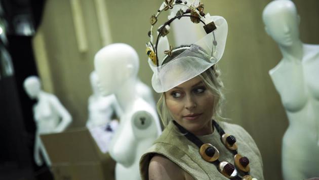 A model wears a creation partially made of chocolate backstage before a fashion show during an annual chocolate festival in Brussels, Thursday, Feb. 13, 2020. (AP Photo/Francisco Seco) (AP)