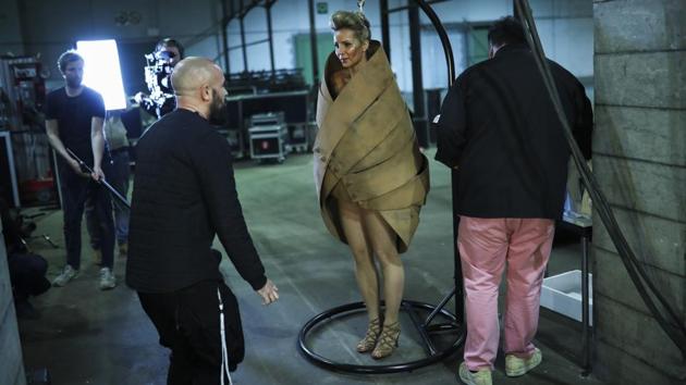 A model puts on a creation made of chocolate backstage before a fashion show during an annual chocolate festival in Brussels, Thursday, Feb. 13, 2020. (AP Photo/Francisco Seco) (AP)