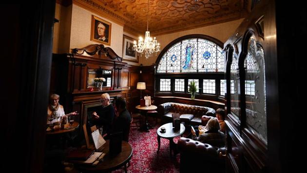 Patrons at The Philharmonic Dining Rooms pub. “So it’s got real rich history as well. And Liverpool is a city that’s quite interesting anyway. So, this is just the icing on the cake for tourists really,” Lavin said. (Paul Ellis / AFP)