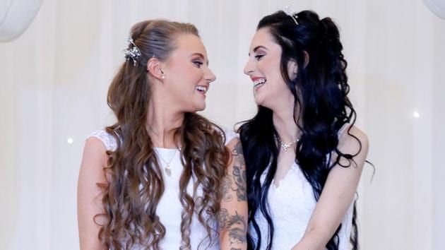 Sharni Edwards (27) and Robyn Peoples (26), a Belfast couple who are the first known same-sex couple to get married in Northern Ireland, smile after being married, in Carrickfergus, Northern Ireland on February 11.The Belfast couple became the first same-sex couple to get married in Northern Ireland after a change in the law came into effect. (Phil Noble / REUTERS)