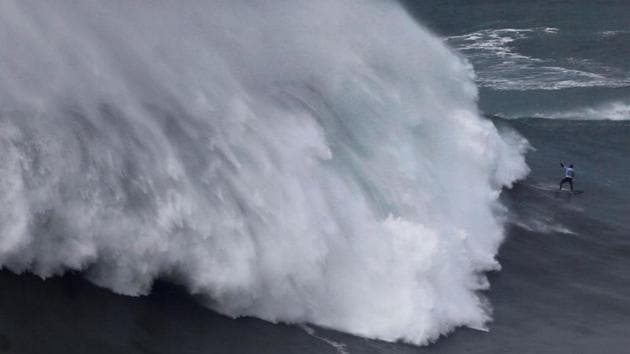 German surfer Sebastian Steudtner drops in on a large wave during the Nazare Tow Challenge at Praia do Norte in Nazare, Portugal. (Rafael Marchante / REUTERS)