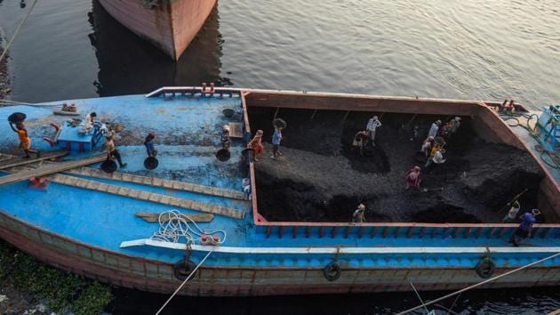 Labourers unload coal off a cargo ship on the outskirts of Dhaka, Bangladesh. (Munir UZ Zaman / AFP)