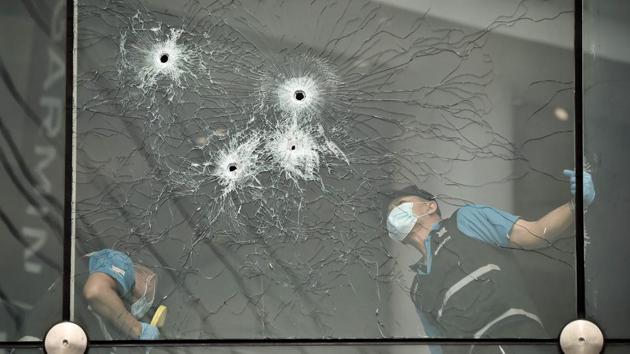 Forensics police inspect bullet holes inside the Terminal 21 shopping mall, where a mass shooting took place, in the Thai northeastern city of Nakhon Ratchasima. A Thai soldier who killed at least 20 people and holed up in a mall overnight was shot dead by commandos on February 9, ending a near-17-hour ordeal which left dozens wounded and stunned the country. (Lillian Suwanrumpha / AFP)