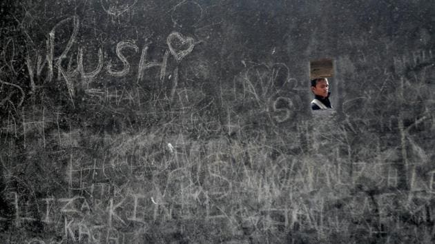 A man walks past a fort wall covered with graffiti on Valentine's Day in Mumbai. (Francis Mascarenhas / REUTERS)