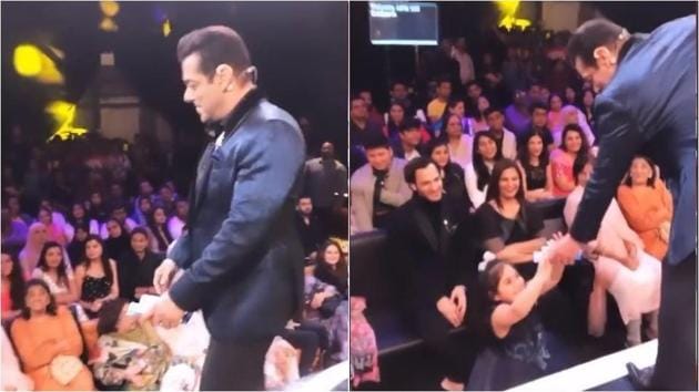 Salman Khan offering chocolates to a young girl during Bigg Boss.