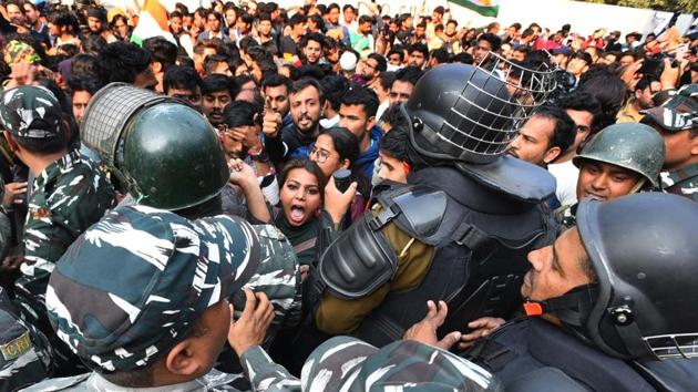 Delhi police personnel and demonstrators in a scuffle during a march to Parliament against the Citizenship Amendment Act, NRC and NPR near Jamia Millia Islamia, in New Delhi. The police had stopped the protesters after they had marched for two kilometres and appealed them not to go further as there was no permission and prohibitory orders had been imposed. (Raj K Raj / HT Photo)