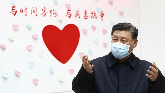 Chinese President Xi Jinping gestures near a heart shape sign and the slogan "Race against time, Fight the Virus" during an inspection of the center for disease control and prevention of Chaoyang District in Beijing. (AP) Chinese President Xi Jinping gestures near a heart shape sign and the slogan "Race against time, Fight the Virus" during an inspection of the center for disease control and prevention of Chaoyang District in Beijing. (AP)