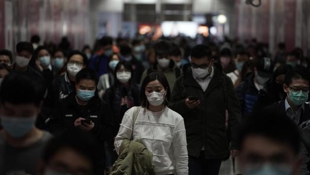 People wearing masks, walk in a subway station, in Hong Kong. (AP Photo) People wearing masks, walk in a subway station, in Hong Kong. (AP Photo)