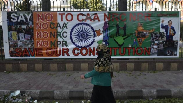 A woman walks near a protest site against Citizenship Amendment Act (CAA), NRC and NPR , at Jamia Millia Islamia University, in New Delhi, on Friday, February 14, 2020.(Burhaan Kinu/HT PHOTO)