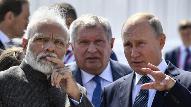 Russian President Vladimir Putin, right, and Prime Minister Narendra Modi, left, talk to each other as they visited shipyard Zvezda, outside the far-eastern Russian port of Vladivostok on September 2019.(AP)