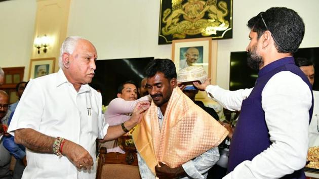 Srinivas Gowda being felicitated by Karnataka Chief Minister BS Yediyurappa on Monday.(ANI Photo)