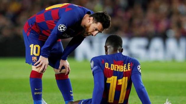 Barcelona's Lionel Messi talks to Ousmane Dembele as he is down injured.(REUTERS)
