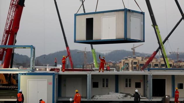 Workers labour at the construction site of the new Huoshenshan Hospital, a makeshift hospital for treating patients of the new coronavirus, in Wuhan. The city’s first makeshift hospital, Huoshenshan—built from scratch in just eight days—started to receive patients on February 03. (China Daily via REUTERS)