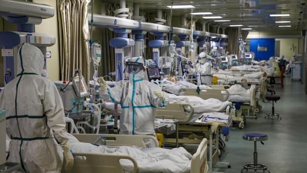 Medical workers attend to novel coronavirus patients at the intensive care unit (ICU) of a designated hospital in Wuhan. The death toll in mainland China reached 1,770 as of Sunday-end, up by 105 from the previous day, while there were 2,048 new cases, bringing the total count to 70,548. (China Daily via REUTERS)