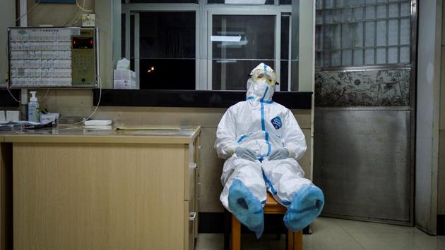 A medical worker takes a break during her night shift at a community health service centre, which has an isolated section to receive patients with mild symptoms caused by the novel coronavirus and suspected patients, in Wuhan. The COVID-19 coronavirus has taken a growing toll on Chinese health workers on the front line of the fight to stop it, a top official said on Friday. (China Daily via REUTERS)