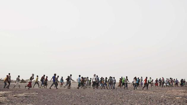 Smugglers lead Ethiopian migrants. Ibrahim, 22, had never been able to find a job and eventually thought of going to Saudi Arabia. He reached out to the local “door opener”—a broker who would link him to smugglers along the way. Often migrants are told they can pay when they reach. Those who spoke to the AP said they were initially quoted prices ranging from $300 to $800 for the journey. (Nariman El-Mofty / AP)
