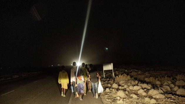 Mohammed Eissa, at the front of the group, around 50km from Djibouti. Eissa decided he would not use smugglers for this journey. The first time, in 2011, he worked as a steel worker in the kingdom, making $25 a day and earning enough to buy a plot of land in the Arsi region’s main town, Asella. He made the trip again two years later but was arrested and deported. (Nariman El-Mofty / AP)
