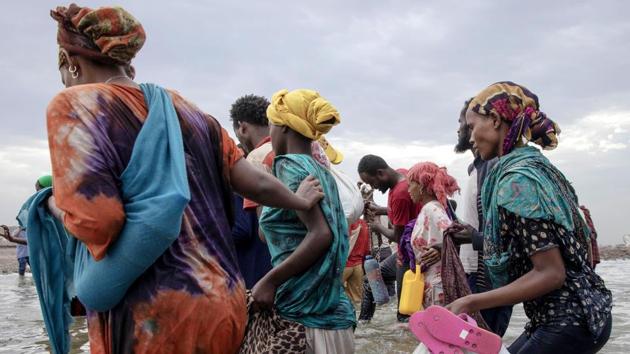 Migrants disembark on the shores of Ras al-Ara, Yemen. Eissa made the crossing another day, paying about $65 to a boat captain. Ibrahim took an alternative route, through Somalia to reach the town of Las Anoud. For 12 days, he was imprisoned, tortured and extorted. They transported him through the port of Bosaso on a wooden boat with some 300 other men and women, “like canned sardines,” he said. (Nariman El-Mofty / AP)